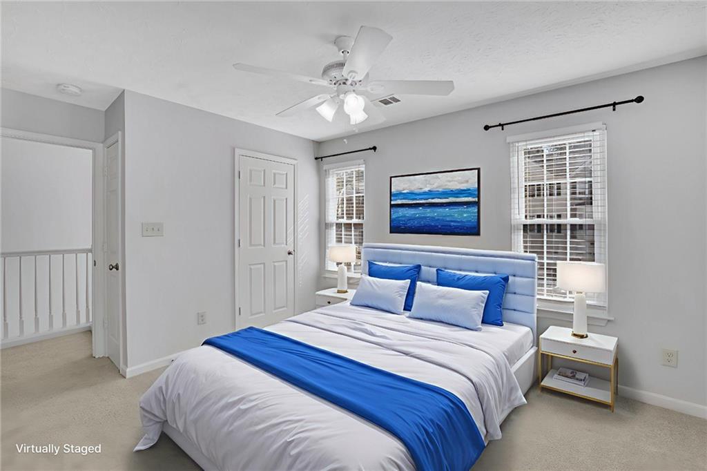 4085 Spring Cove Drive Duluth, GA 30097 - Photo 28 of 45 a bedroom with a large bed and a chandelier