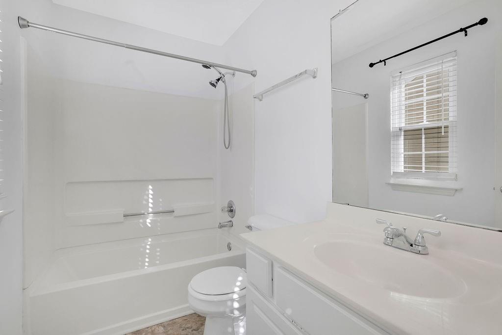 4085 Spring Cove Drive Duluth, GA 30097 - Photo 30 of 45 a bathroom with a granite countertop bathtub shower sink vanity and toilet