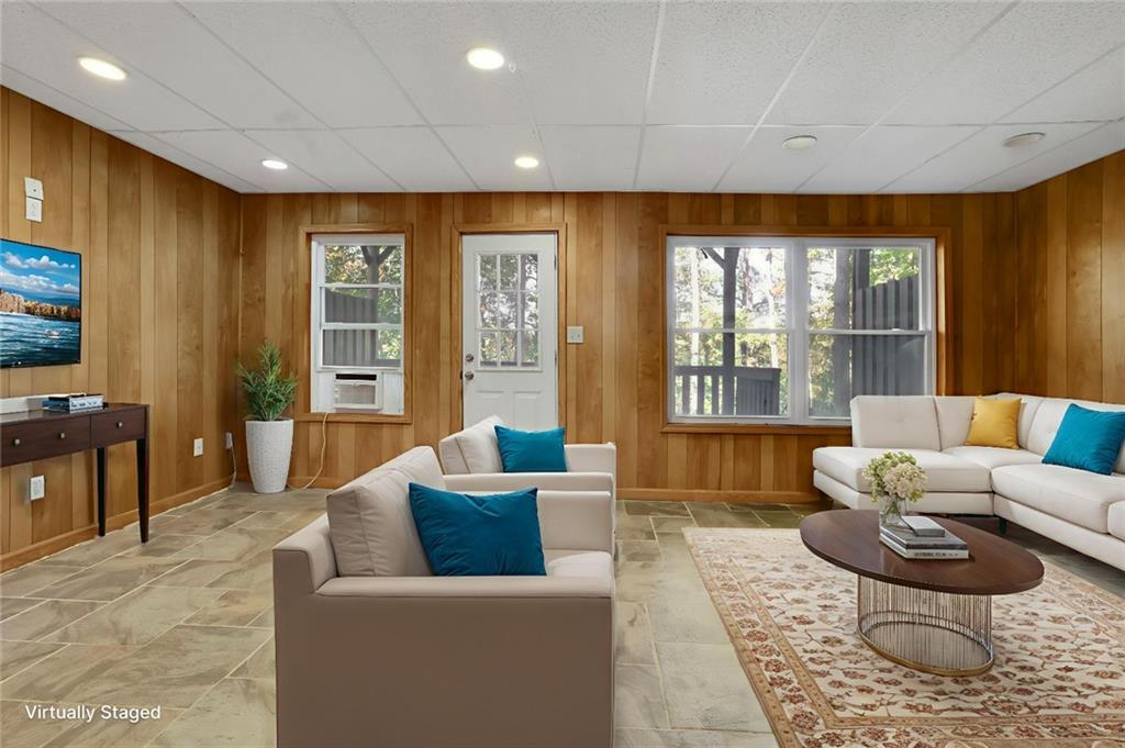 4085 Spring Cove Drive Duluth, GA 30097 - Photo 32 of 45 a living room with furniture and a flat screen tv