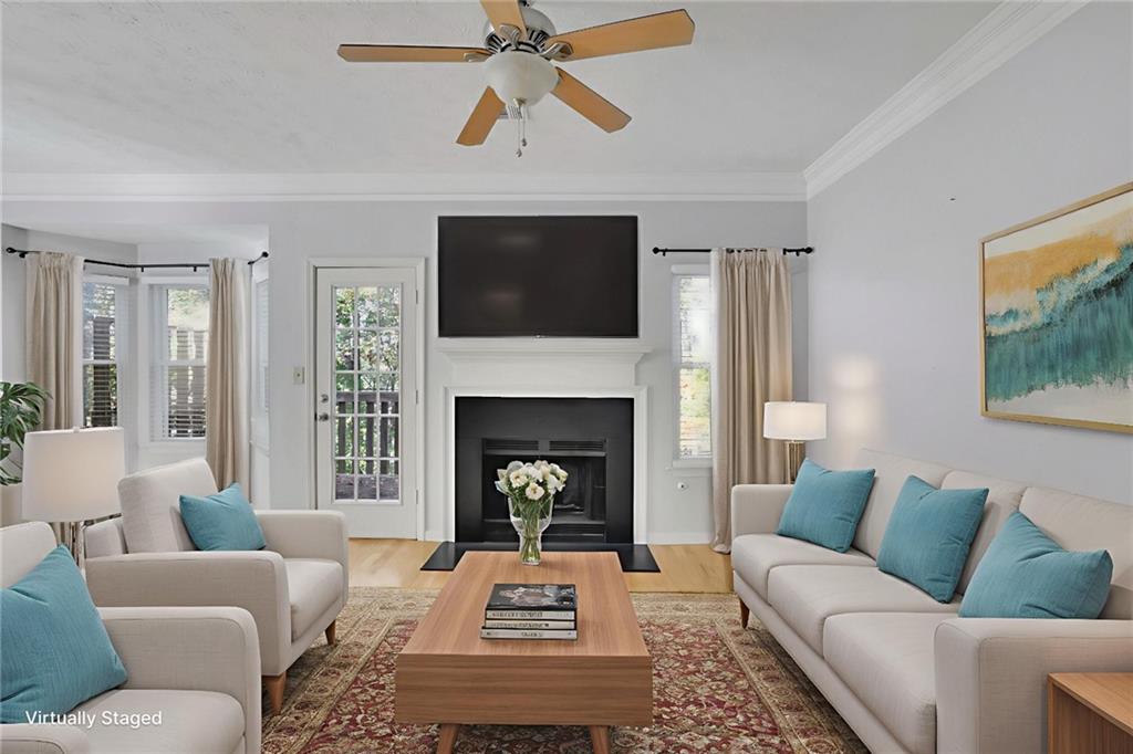 4085 Spring Cove Drive Duluth, GA 30097 - Photo 5 of 45 a living room with furniture and a fireplace