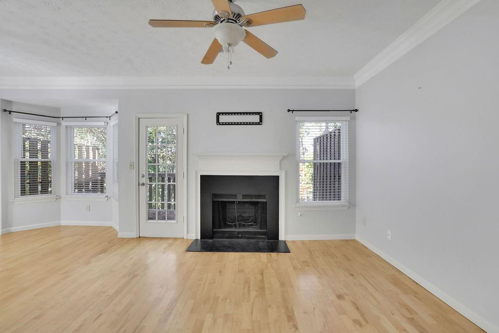 4085 Spring Cove Drive Duluth, GA 30097 - Photo 6 of 45 a view of an empty room with a fireplace and a window