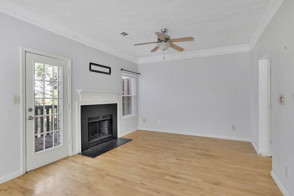 4085 Spring Cove Drive Duluth, GA 30097 - Photo 7 of 45 a view of empty room with fireplace and fan