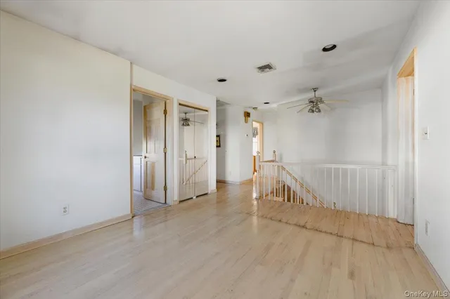 a spacious bedroom with a bed and a flat screen tv
