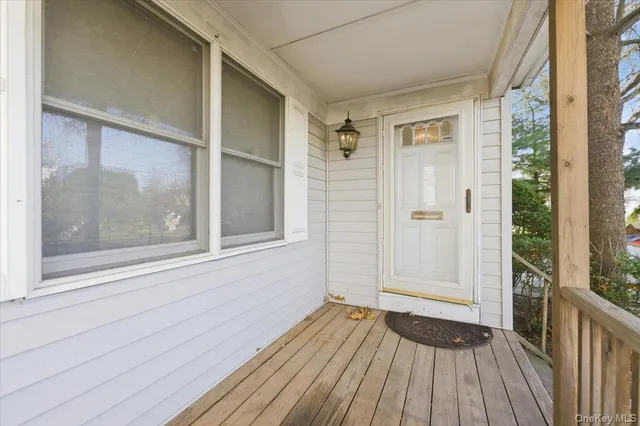 a view of a room with wooden floor and windows