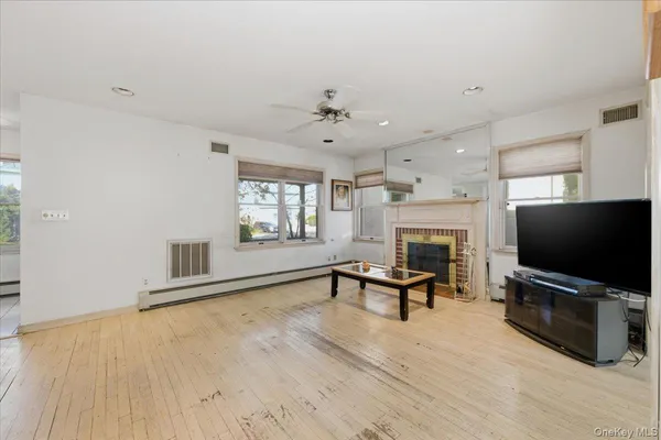 a living room with furniture flat screen tv and a fireplace