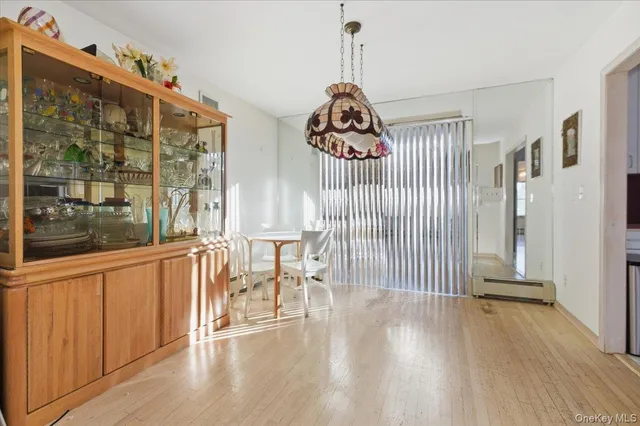 a view of a livingroom with wooden floor and furniture