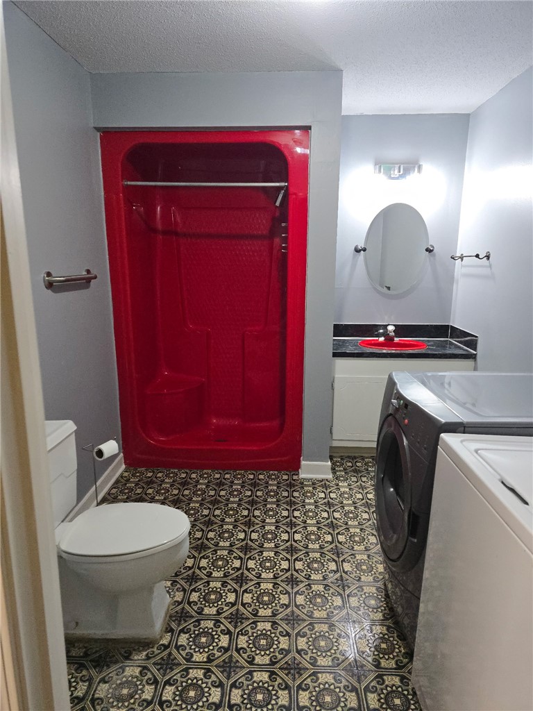 418 Saluda Road Williamston, SC 29697 - Photo 22 of 43 Functional full bathroom featuring a striking red shower enclosure and patterned flooring. Basement bathroom