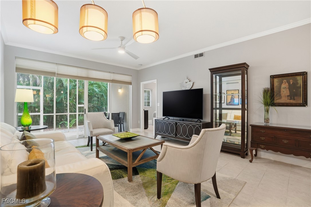 770 Luisa Lane, Unit 3 Naples, FL 34104 - Photo 14 of 38 a living room with furniture and a flat screen tv