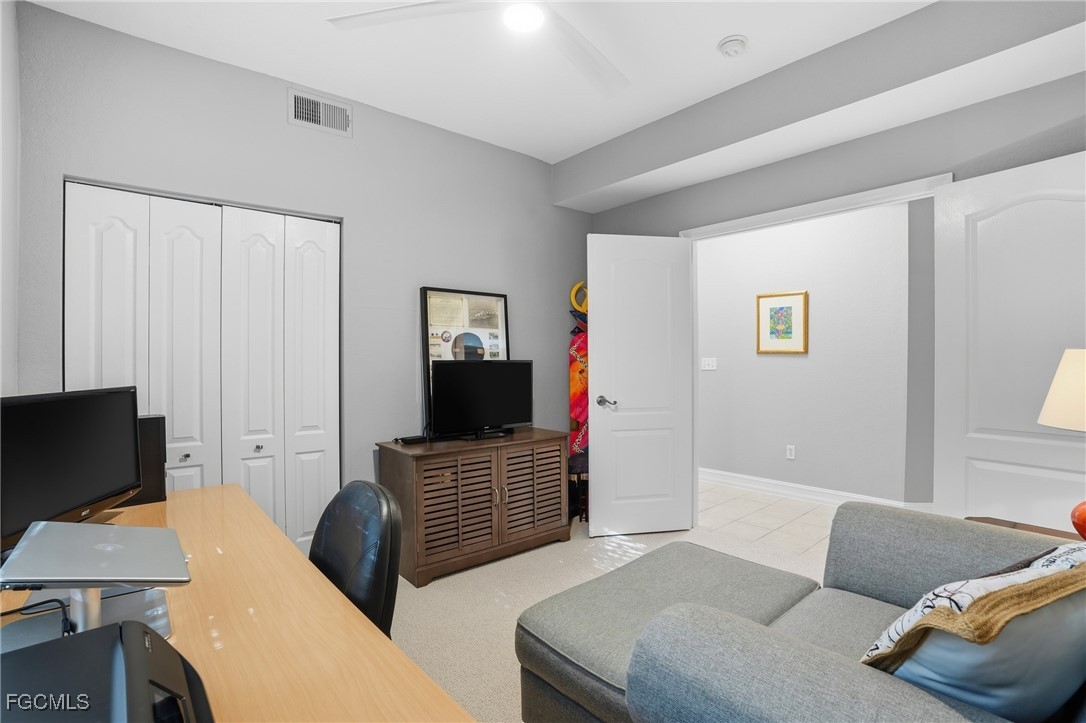 770 Luisa Lane, Unit 3 Naples, FL 34104 - Photo 25 of 38 a living room with furniture and a flat screen tv