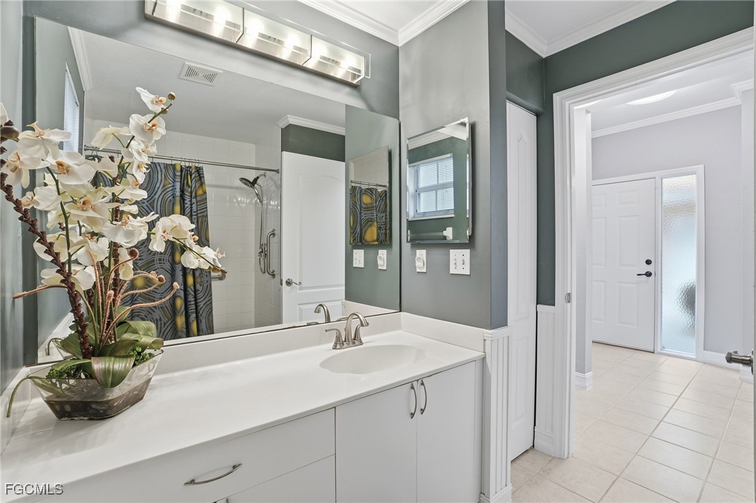 770 Luisa Lane, Unit 3 Naples, FL 34104 - Photo 27 of 38 a bathroom with a sink a toilet and a mirror