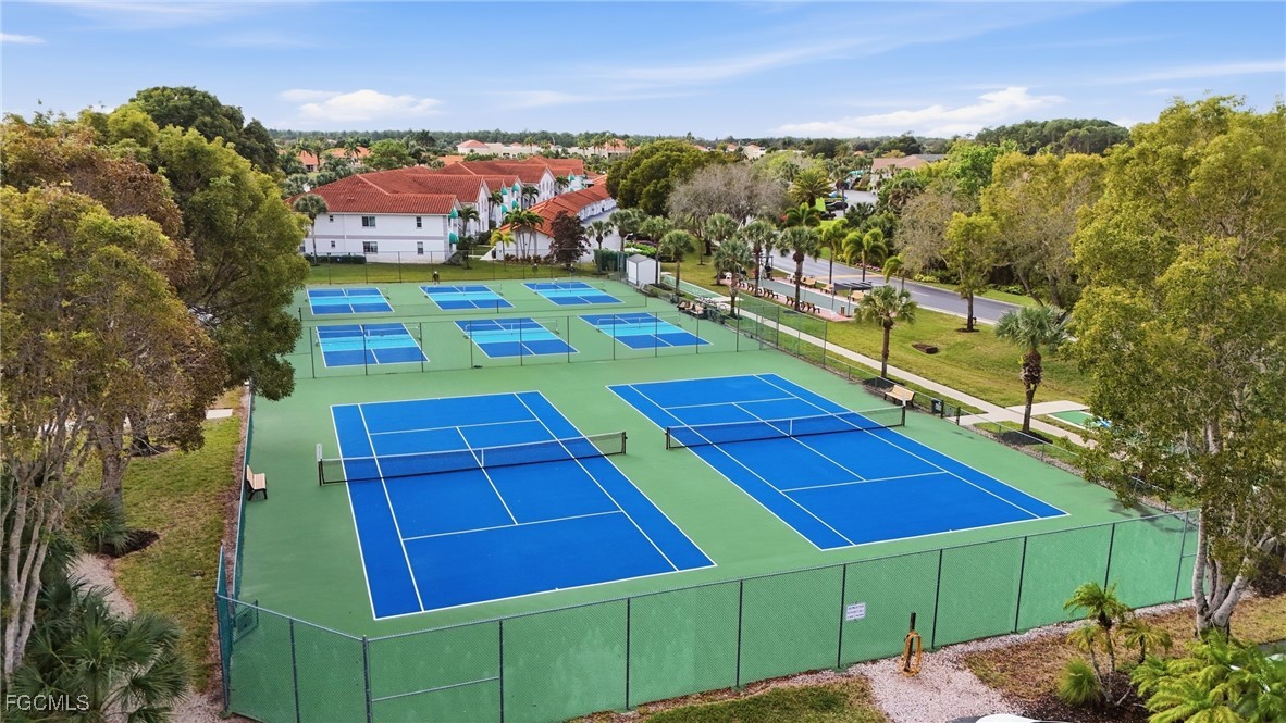 770 Luisa Lane, Unit 3 Naples, FL 34104 - Photo 30 of 38 a view of a tennis ground with a swimming pool