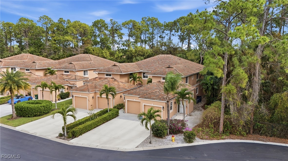 770 Luisa Lane, Unit 3 Naples, FL 34104 - Photo 38 of 38 an aerial view of a house with yard and outdoor seating