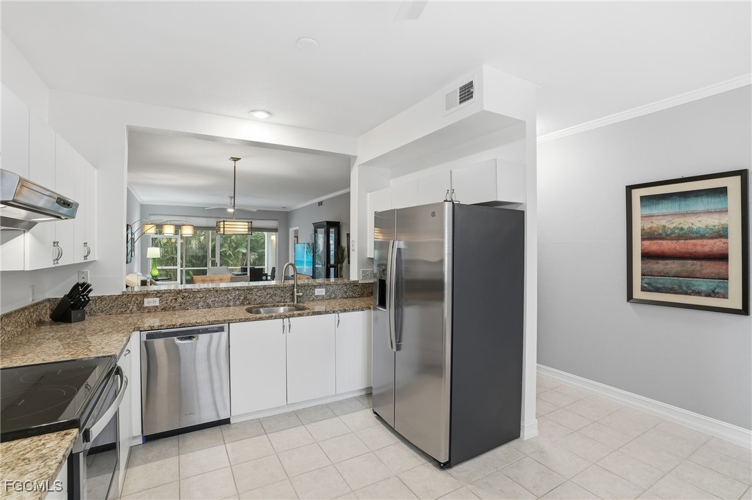 770 Luisa Lane, Unit 3 Naples, FL 34104 - Photo 6 of 38 a kitchen with stainless steel appliances granite countertop a refrigerator and a sink