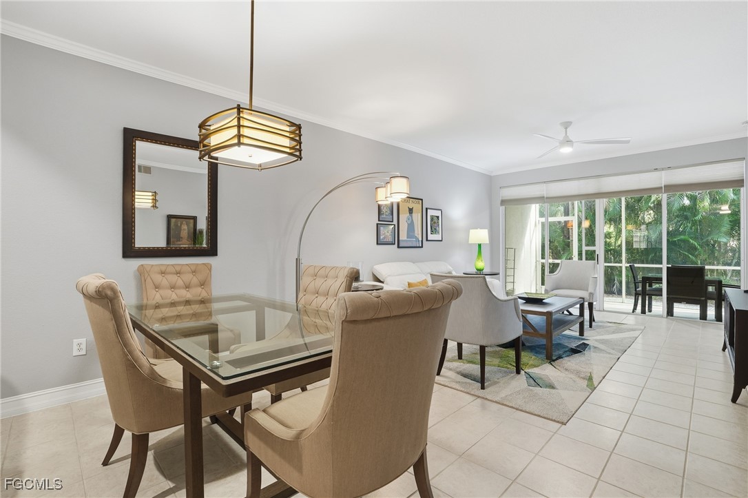 770 Luisa Lane, Unit 3 Naples, FL 34104 - Photo 10 of 38 a dining room with furniture a chandelier and wooden floor