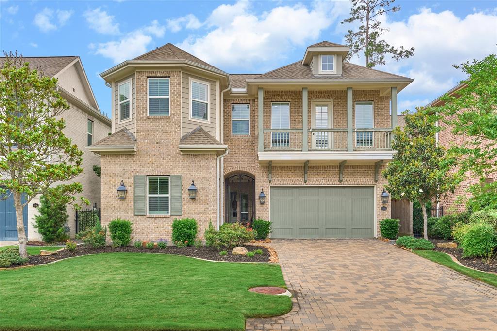 Exquisite brick exterior with 2-car garage, pristine landscaping and second story balcony.