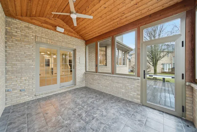a spacious bathroom with a granite countertop tub sink a mirror a bathtub and window