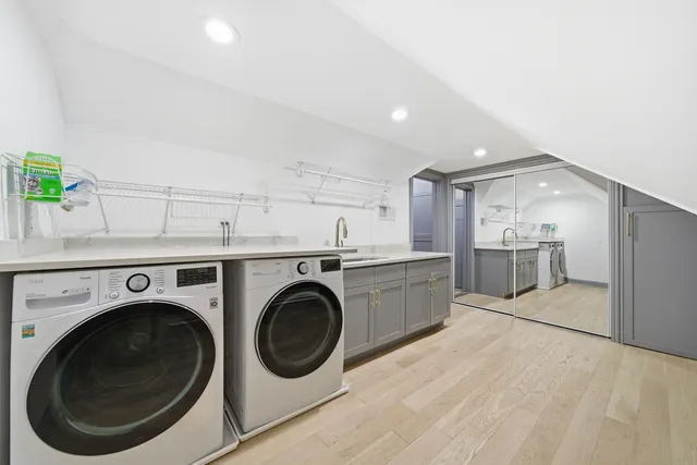 an empty room with wooden floor fireplace and windows