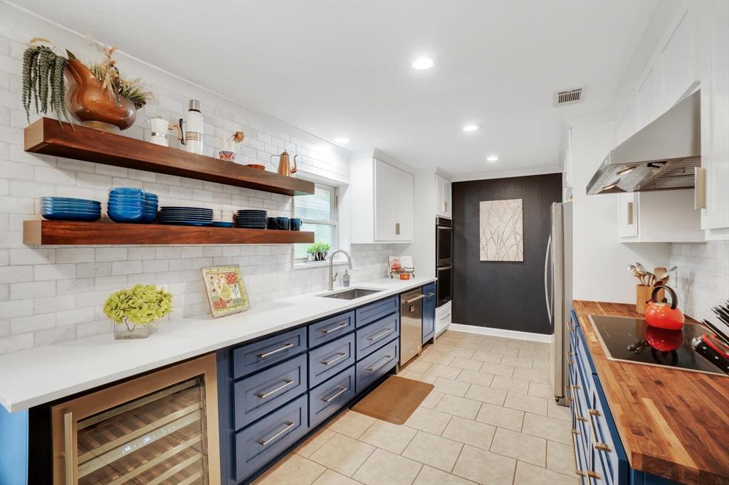 a kitchen with stainless steel appliances granite countertop a sink and cabinets