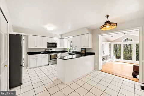 a kitchen with stainless steel appliances a stove a sink a microwave and cabinets