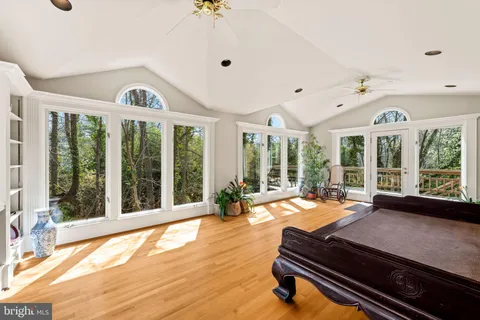 a living room with hardwood floor and a large window
