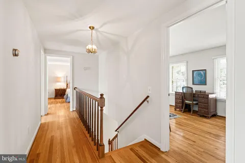 a bedroom with bed and wooden floor