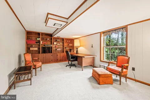 a view of a patio with a table and chairs and wooden fence