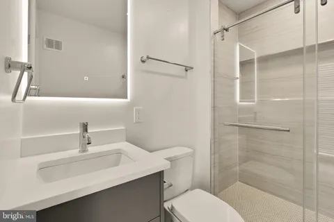 a bathroom with a sink toilet and shower