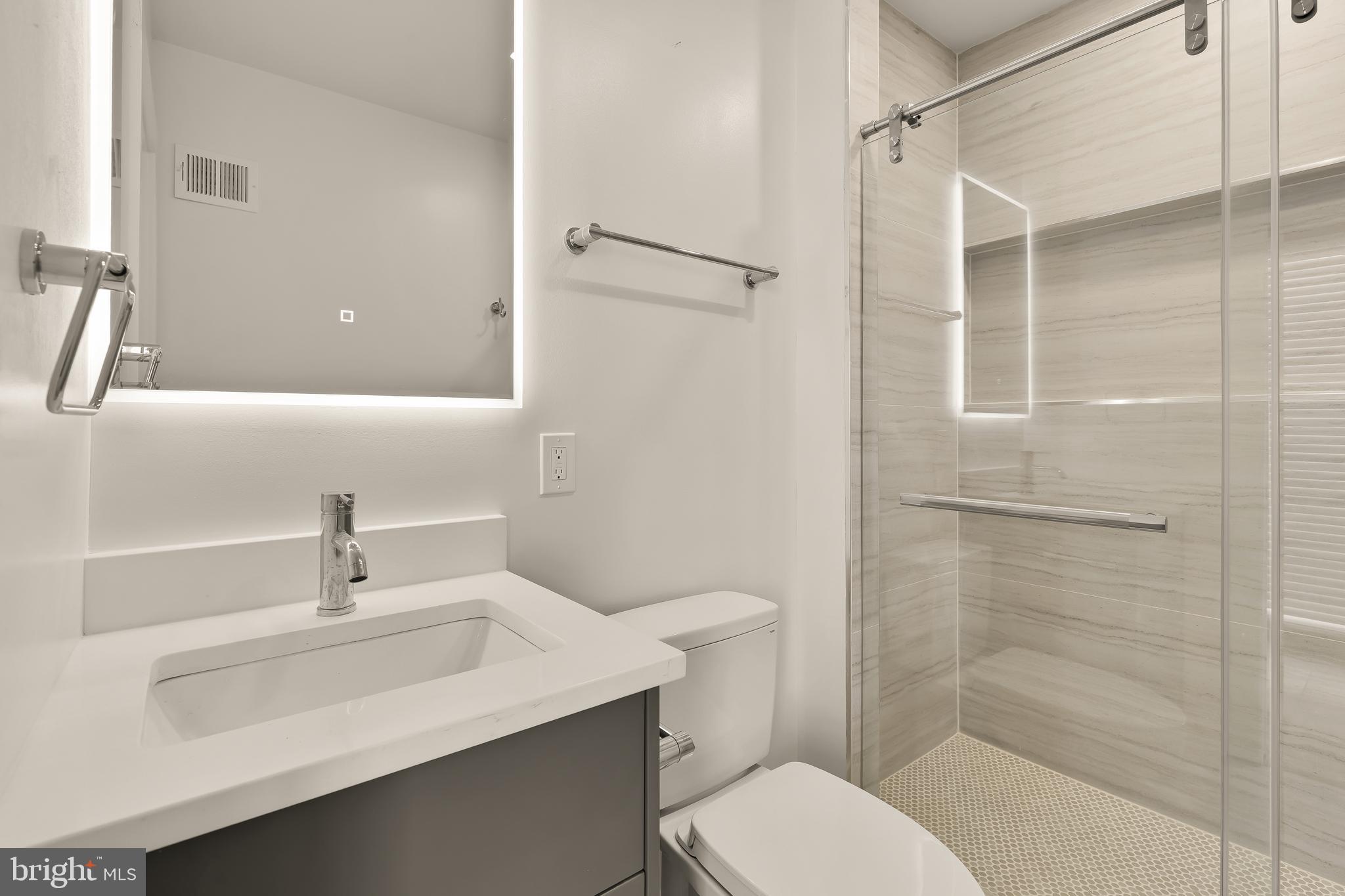 641 Quebec Place Northwest, Unit 1 Washington, DC 20010 - Photo 18 of 30 a bathroom with a sink toilet and shower