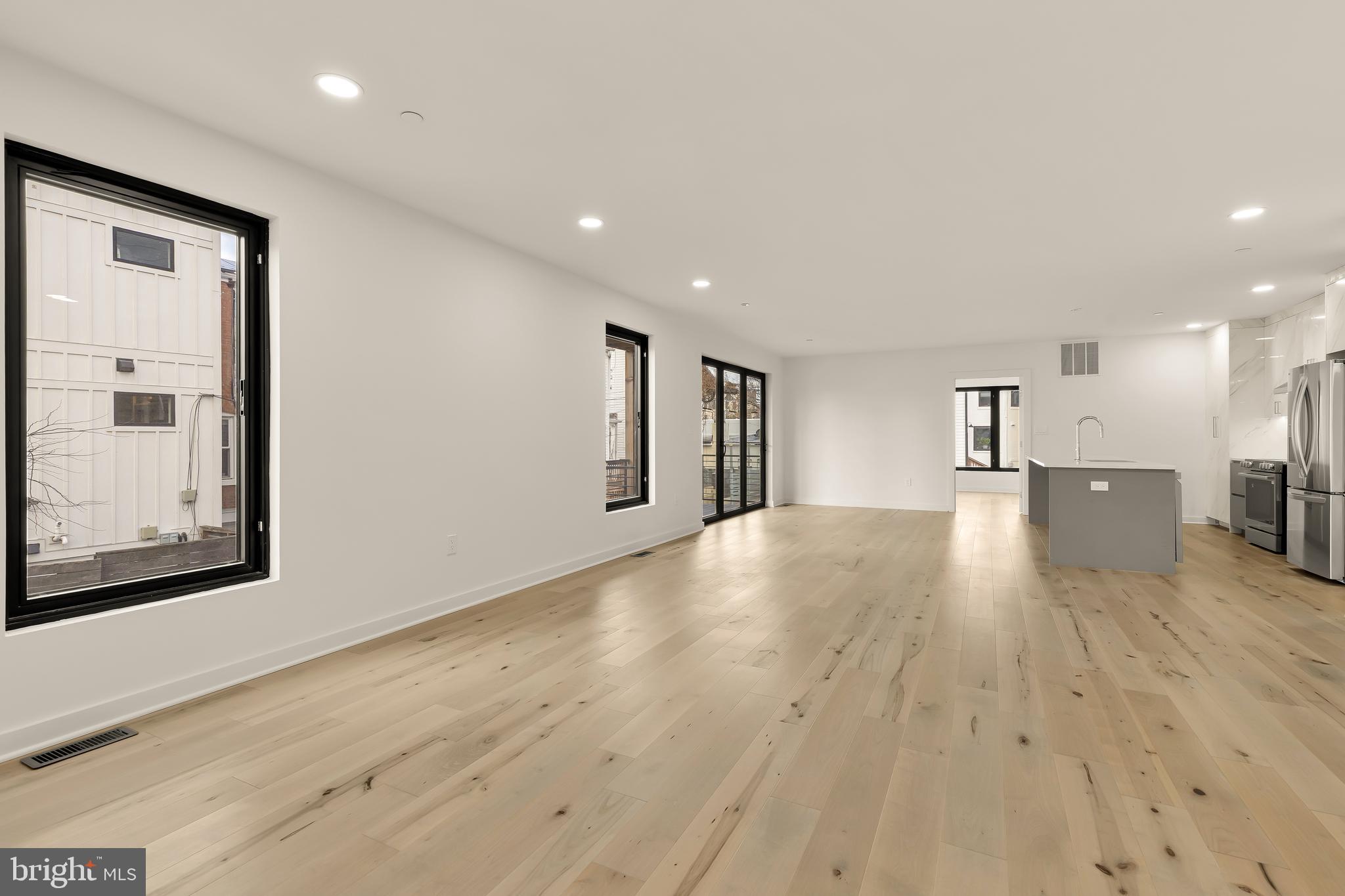 641 Quebec Place Northwest, Unit 1 Washington, DC 20010 - Photo 2 of 30 a view of empty room with wooden floor and windows