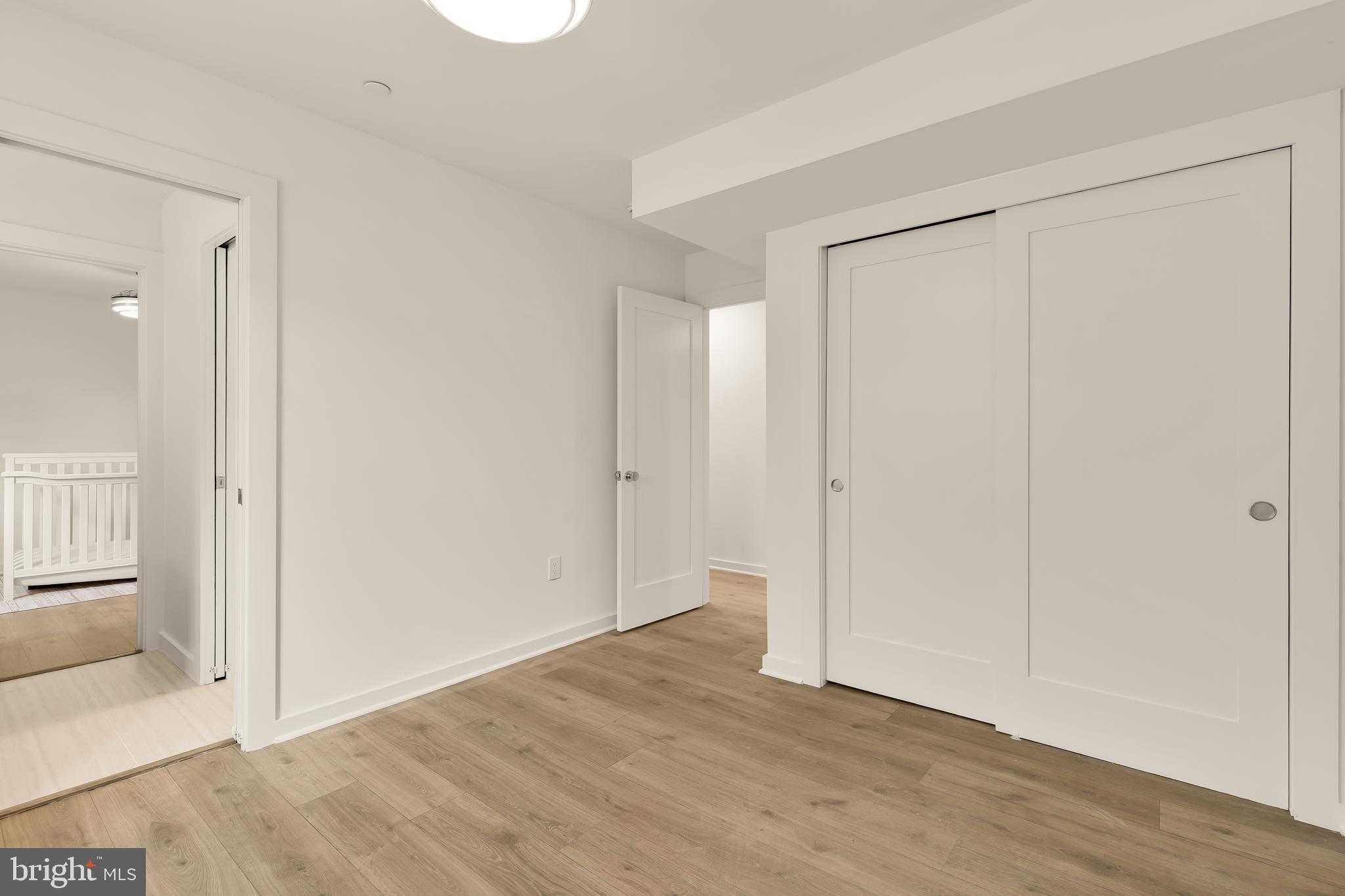641 Quebec Place Northwest, Unit 1 Washington, DC 20010 - Photo 25 of 30 an empty room with wooden floor and windows
