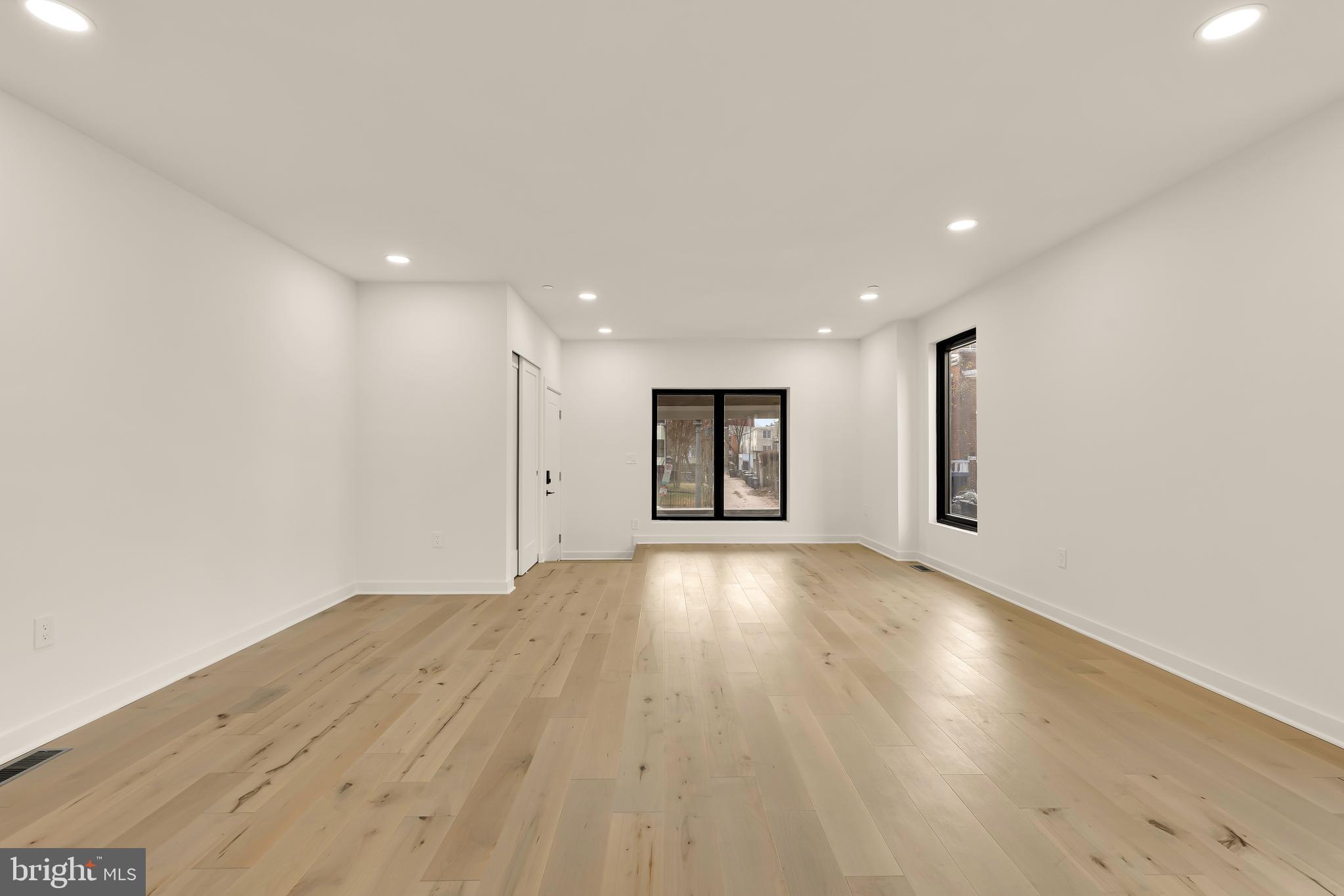 641 Quebec Place Northwest, Unit 1 Washington, DC 20010 - Photo 4 of 30 an empty room with wooden floor and windows