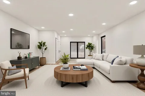 a living room with furniture and a potted plant