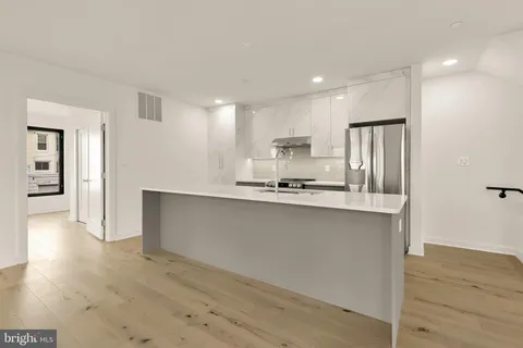 a view of kitchen with wooden floor