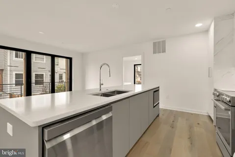 a large white kitchen with sink