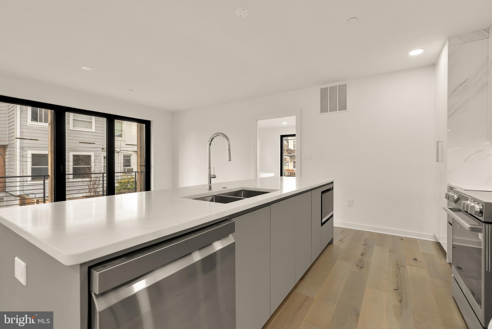641 Quebec Place Northwest, Unit 1 Washington, DC 20010 - Photo 10 of 30 a large white kitchen with sink