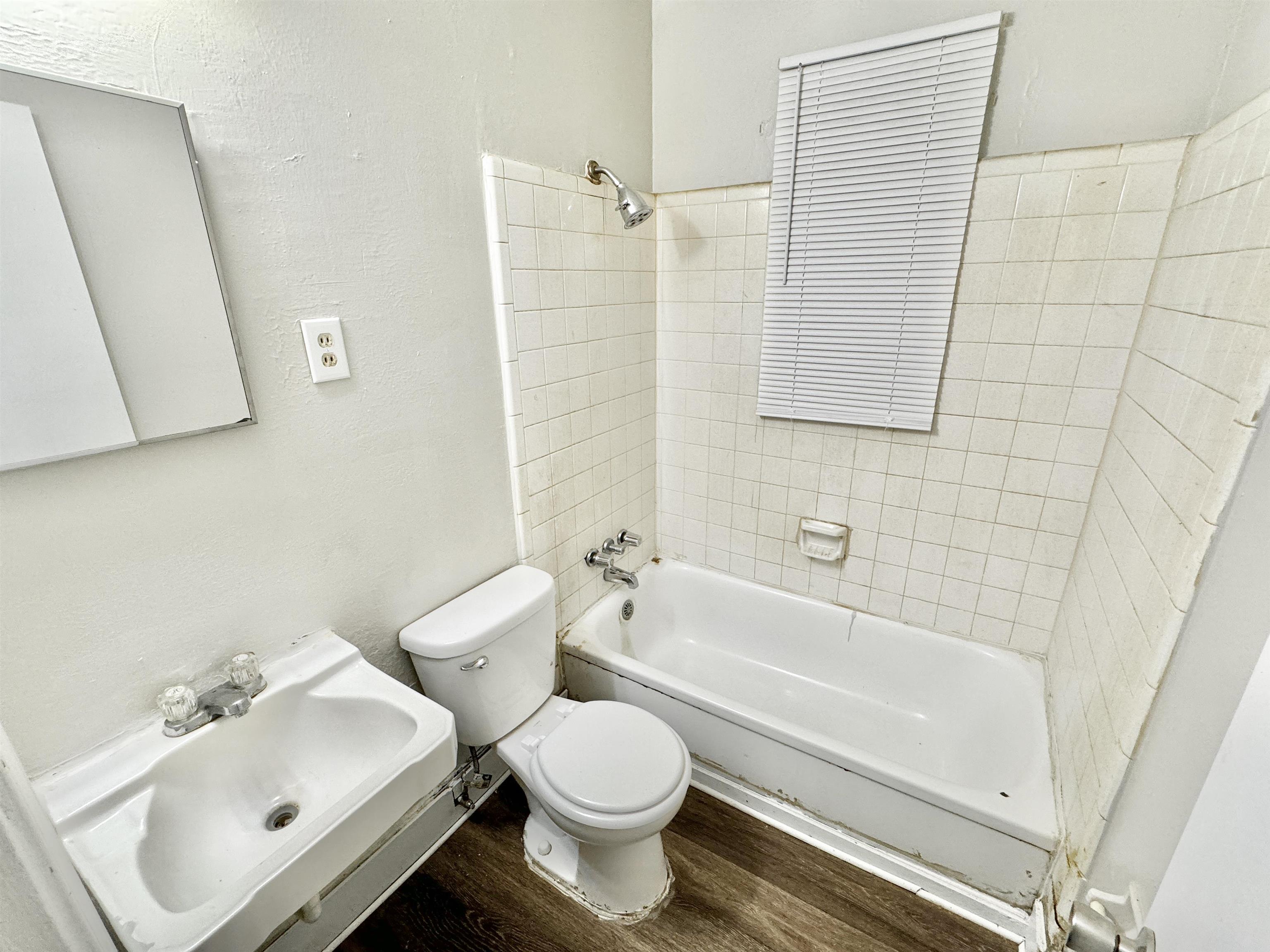 1616 Oberle Road Memphis, TN 38127 - Photo 11 of 15 Bathroom with tiled shower / bath combo, toilet, and hardwood / wood-style flooring