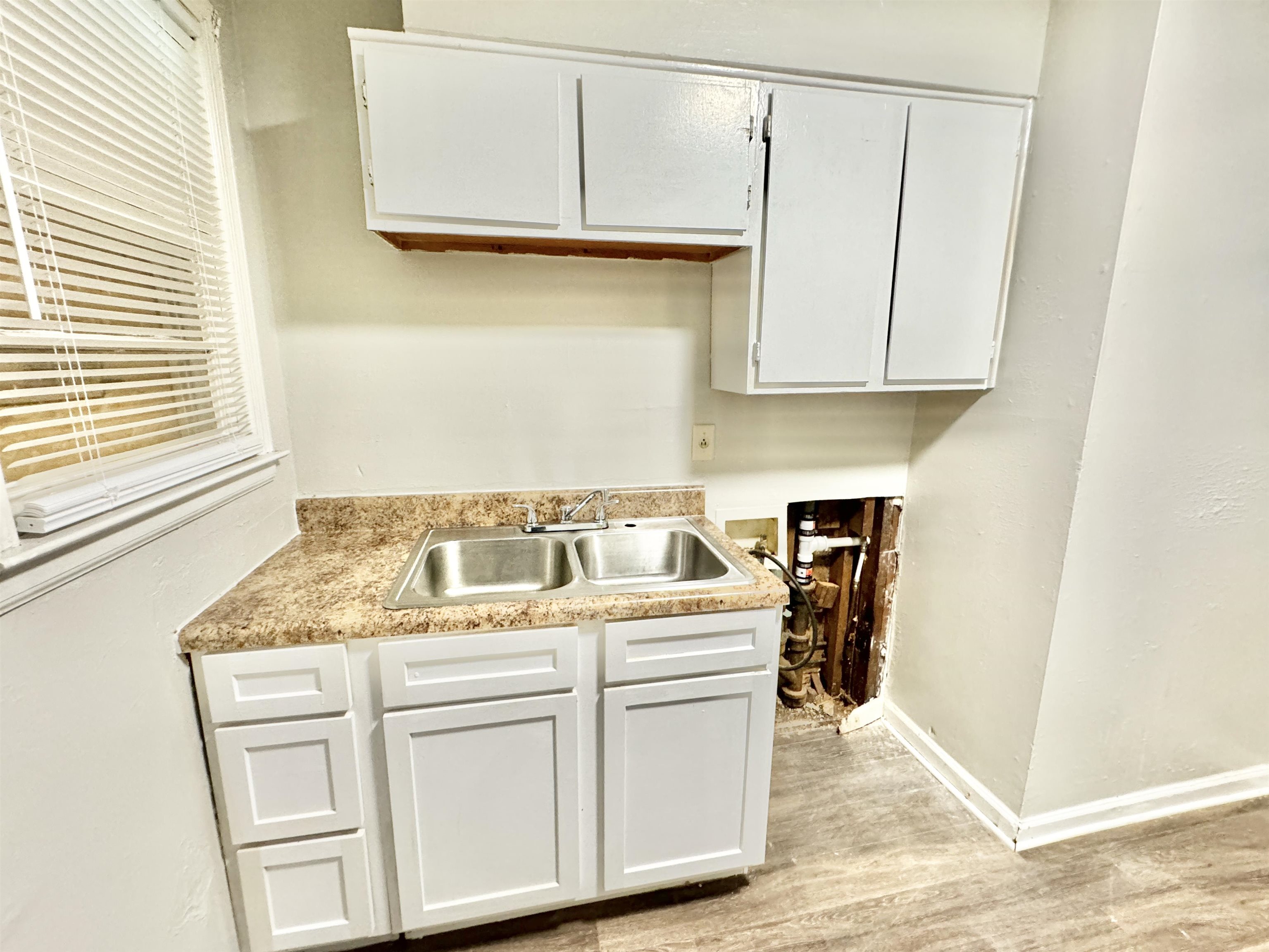 1616 Oberle Road Memphis, TN 38127 - Photo 4 of 15 Kitchen with light hardwood / wood-style floors, sink, and white cabinetry