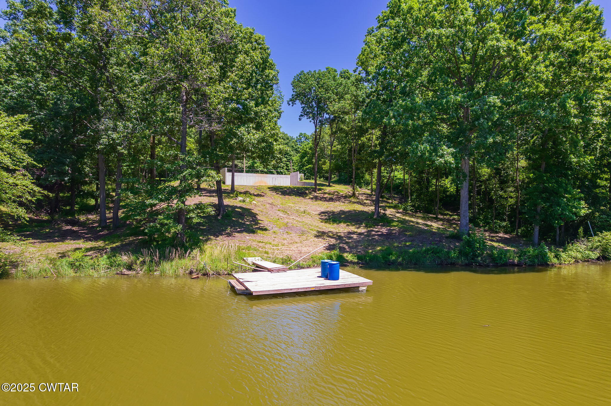 64 Lake Hayes Estates Road Trenton, TN 38382 - Photo 15 of 25 a view of a lake with a house in the background