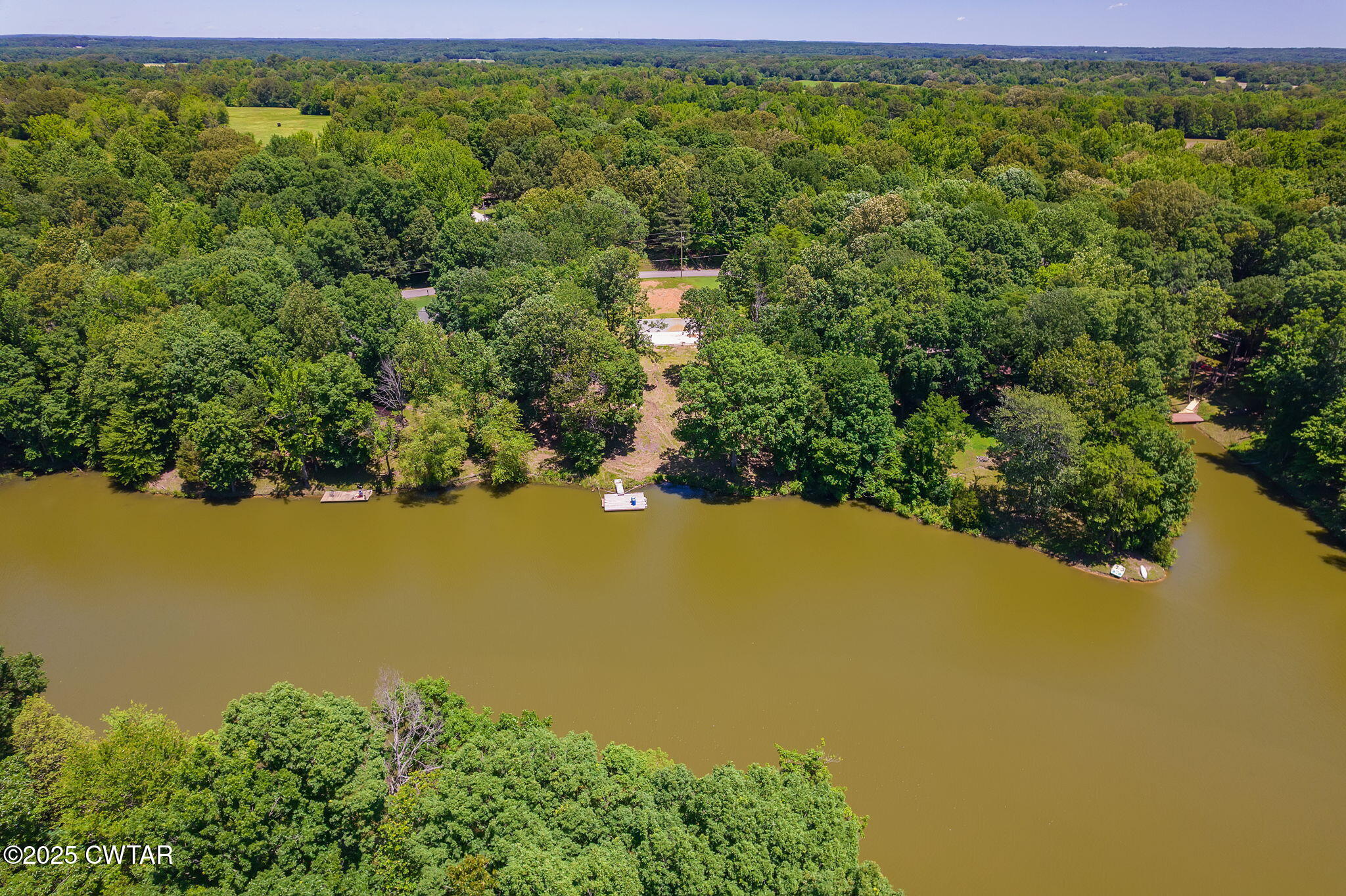 64 Lake Hayes Estates Road Trenton, TN 38382 - Photo 19 of 25 a view of a lake with a house in the background