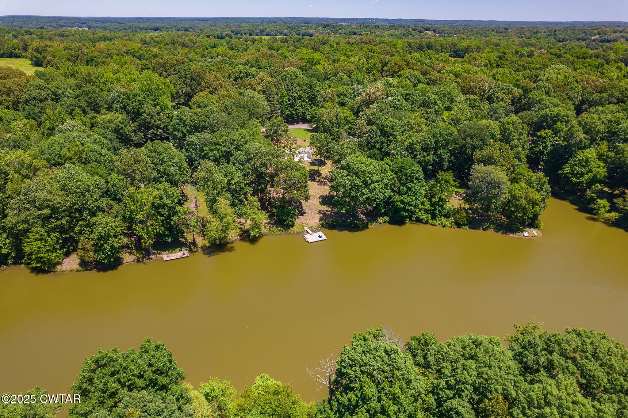 64 Lake Hayes Estates Road Trenton, TN 38382 - Photo 20 of 25 a view of a lake with a building in the background