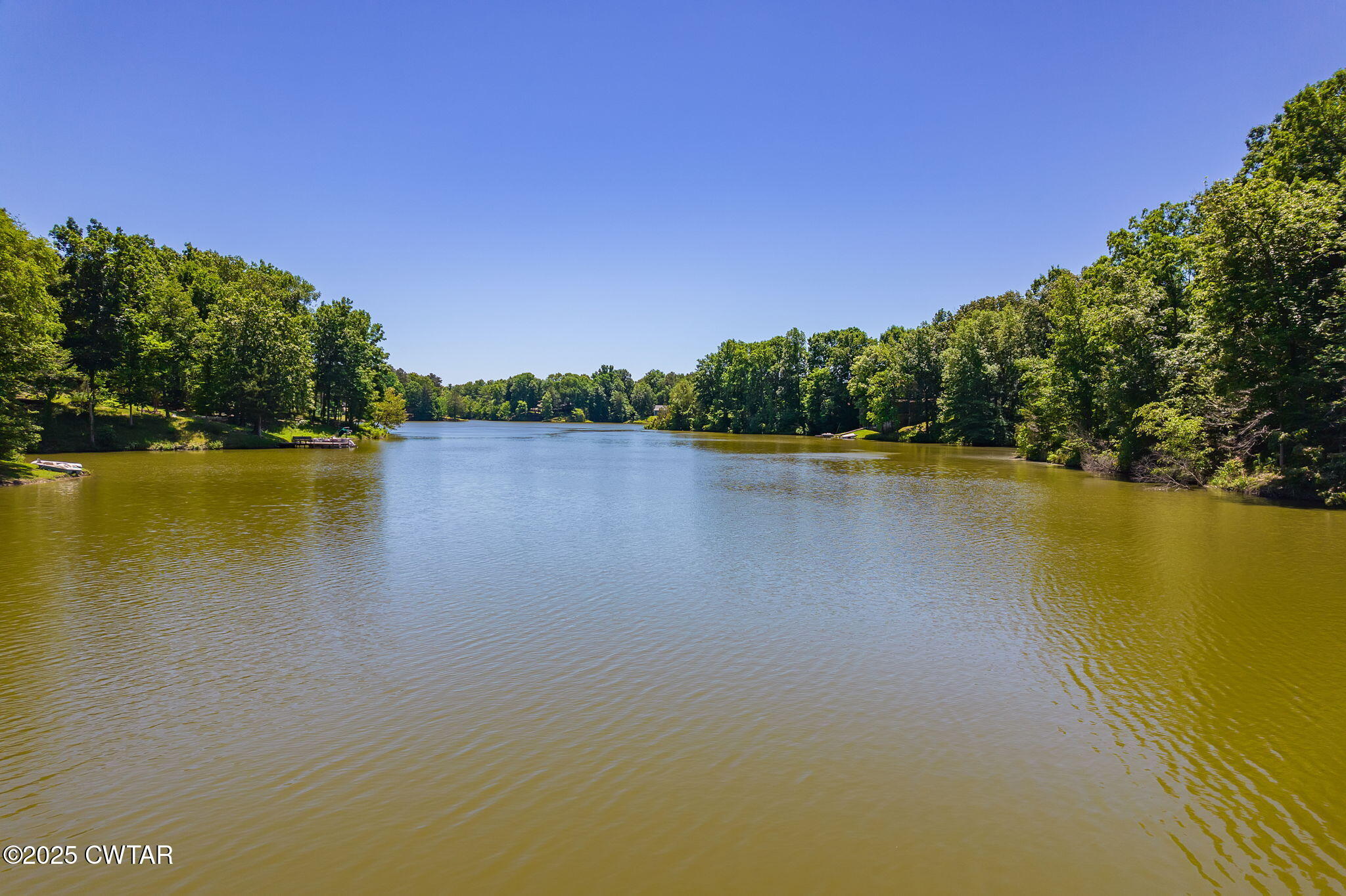 64 Lake Hayes Estates Road Trenton, TN 38382 - Photo 23 of 25 a view of a lake with houses in the background