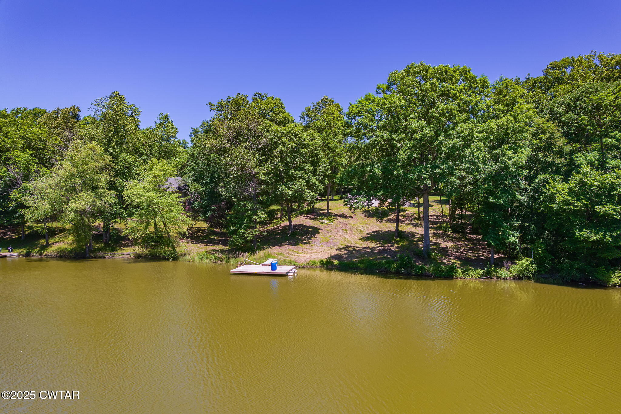 64 Lake Hayes Estates Road Trenton, TN 38382 - Photo 24 of 25 a view of a lake with houses in the back