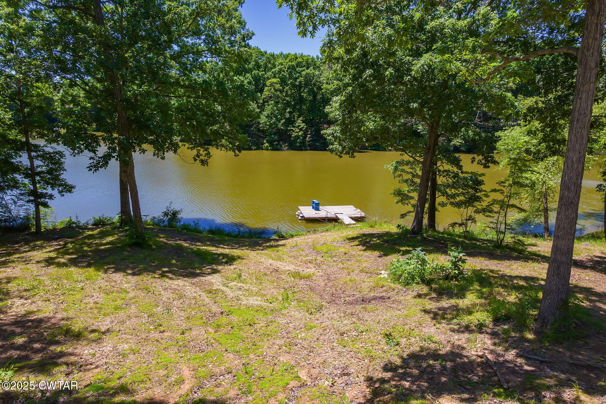 64 Lake Hayes Estates Road Trenton, TN 38382 - Photo 4 of 25 a view of a lake with a yard