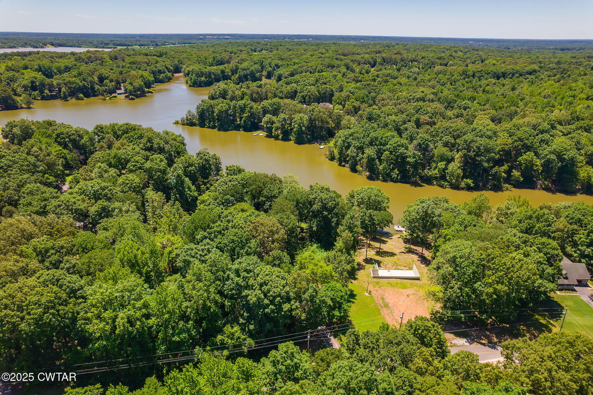 64 Lake Hayes Estates Road Trenton, TN 38382 - Photo 9 of 25 a view of a lake with houses in the back