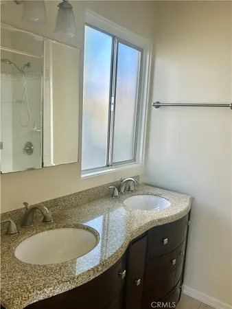 a bathroom with a shower and a sink