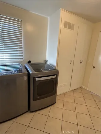 a bathroom with a tub a sink a window and a shower