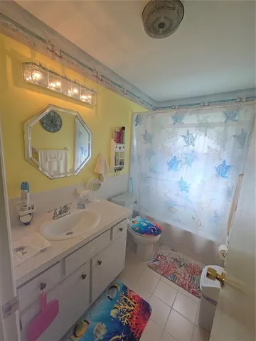 a bathroom with a sink mirror and toilet
