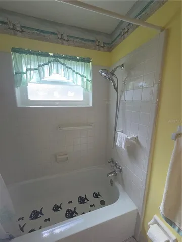 a bathroom with a tub and a window
