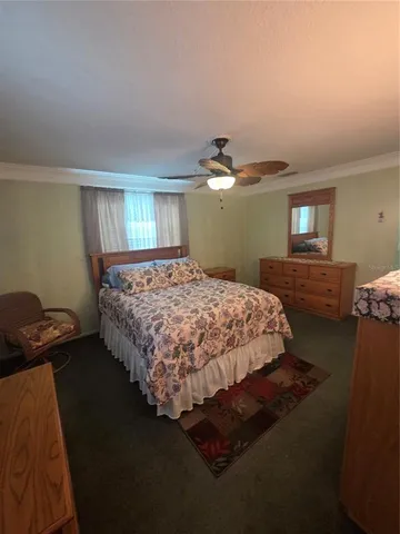 a bedroom with a bed and dresser