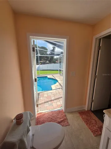 a bedroom with a bed and glass door